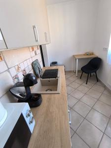 a kitchen with a desk with a computer on it at City Heaven Apartment in Szeged