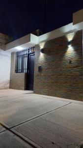 a brick building with a door on the side of it at Sueños Del Pilar II in Godoy Cruz