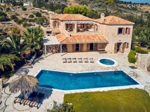an aerial view of a house with a swimming pool at Elegant Zante Villa - Villa Divas - 6 Bedrooms - Infinity Pool - 100 Metres To The Sea - Short Drive To Agios Nikolaos in Koríthion