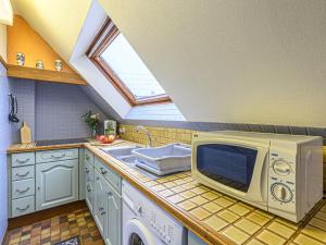 a kitchen with a microwave and a sink at Apartment Les Embruns-1 by Interhome in Carnac