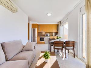 a living room with a couch and a table at Apartment Puigmal by Interhome in Empuriabrava