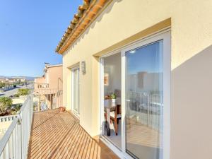 a balcony with sliding glass doors and a table at Apartment Puigmal by Interhome in Empuriabrava