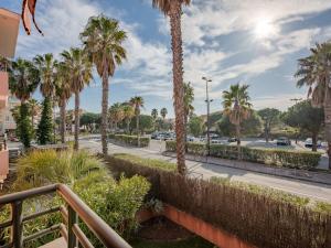 a view of a parking lot with palm trees at Apartment Santa Monica-1 by Interhome in Fréjus