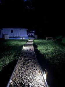 a dark yard at night with a building and a pathway at Back to Nature Squirrels Lodge 1 bedroom lodge in South Molton