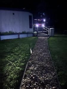 a truck is parked in a yard at night at Back to Nature Squirrels Lodge 1 bedroom lodge in South Molton