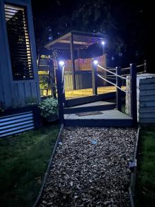 a house with lights on the porch at night at Back to Nature Squirrels Lodge 1 bedroom lodge in South Molton