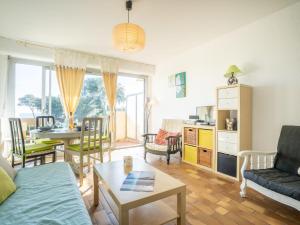 a living room with a couch and a table at Apartment Les Louvans-4 by Interhome in Saint-Aygulf