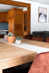 a living room with a table and a couch at Chalet des bois de Criou in Morillon