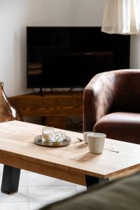 a coffee table in a living room with a chair at Chalet des bois de Criou in Morillon