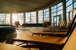 a row of chairs in a room with windows at Thermal Resort Hotel Lendava in Lendava