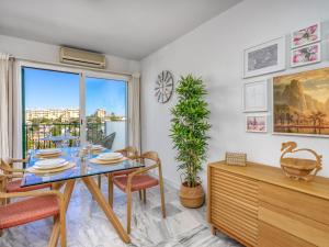 a dining room with a table and chairs and a window at Apartment Angel Blanco by Interhome in La Cala de Mijas