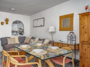 a living room with a table and a couch at Apartment Angel Blanco by Interhome in La Cala de Mijas