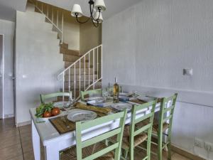 a dining room with a table with chairs and a staircase at Apartment Les Rivages de Coudoulière-10 by Interhome in Six-Fours-les-Plages