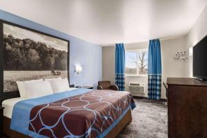 a hotel room with a bed and a window at Super 8 by Wyndham Columbus Edinburgh in Columbus