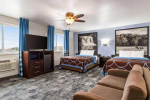 a hotel room with two beds and a flat screen tv at Super 8 by Wyndham Columbus Edinburgh in Columbus