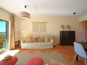 a living room with a white couch and a table at Apartment Vilas Mouriscas by Interhome in Vilamoura +28 photos