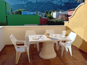 a white table and chairs on a balcony at Apartment Alqueria Sol by Interhome in Denia