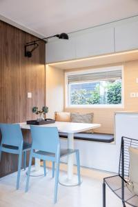 a kitchen and dining room with a table and chairs at Holiday Home Natuurlijk de Veenhoop by Interhome in De Veenhoop