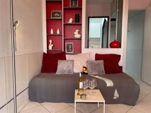 a bedroom with a bed and a table with wine glasses at Apartment Les Jardins du Port-10 by Interhome in Le Grau-du-Roi