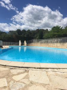 a large swimming pool with blue water at Maison proche Cannes /Grasse in Mouans-Sartoux