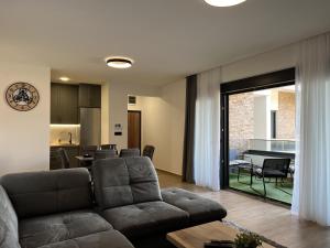 a living room with a couch and a table at Olimpiko in Vrdnik