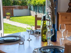 a table with glasses and a bottle of wine on it at Holiday Home Bretagne by Interhome in Carnac +14 photos