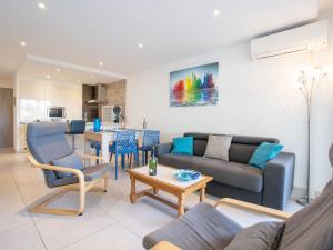 una sala de estar con un sofá y una mesa en Apartment Les Louvans-10 by Interhome, en Saint-Aygulf