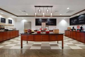 a kitchen with a island in the middle of a room at Hampton Inn Easley in Easley