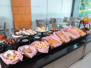 a buffet with many different types of pastries and desserts at ibis Presidente Prudente Manoel Goulart in Presidente Prudente