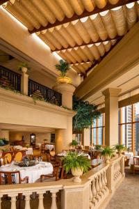 a restaurant with tables and chairs in a building at Grand Hyatt Hong Kong in Hong Kong