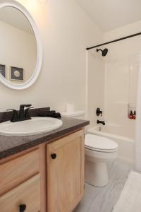 a bathroom with a sink and a toilet and a mirror at Renovated Charleston Oasis Mins to Dtwn and Beach in Charleston