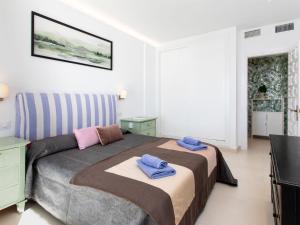 a bedroom with a bed with two towels on it at Apartment Balcón de Cotobro I by Interhome in Almuñécar