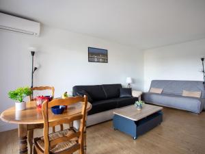 a living room with a couch and a table at Studio Tivoli des Anges by Interhome in Villeneuve-Loubet