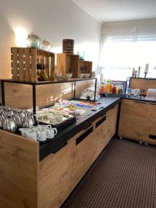 a kitchen with a counter top with food on it at Hotel zum Rosenteich in Bad Zwischenahn