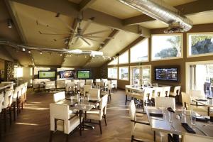 a dining room with tables and chairs and windows at The Hotel at La Valle in Rancho Santa Fe