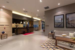 a man standing in a lobby with a waiting room at Hampton Inn by Hilton Hermosillo in Hermosillo