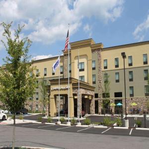 a hotel with two flags in front of it at Hampton Inn & Suites Stroudsburg Bartonsville Poconos in Stroudsburg