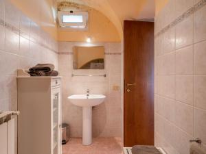 a bathroom with a sink and a mirror at Apartment Ca du Ponte by Interhome in Dolcedo +11 photos