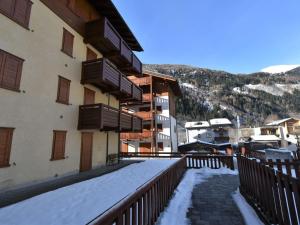 a balcony of a building with snow on the ground at Apartment Cà Serena by Interhome in Campodolcino