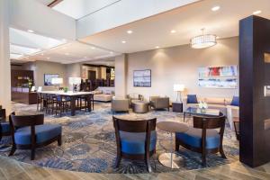 a lobby of a hotel with tables and chairs at DoubleTree by Hilton Jacksonville Riverfront, FL in Jacksonville