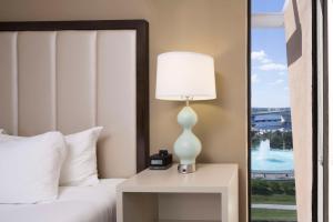 a bedroom with a bed and a lamp on a table at DoubleTree by Hilton Hotel Jacksonville Riverfront in Jacksonville
