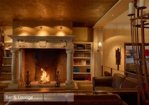 a fireplace in a living room with a fire at Lenkerhof gourmet spa resort - Relais & Châteaux in Lenk