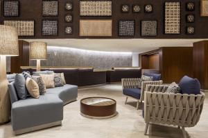 a lobby with couches and chairs and a waiting room at Hilton Garden Inn Waikiki Beach in Honolulu