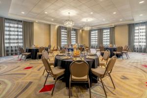 a conference room with tables and chairs and chandeliers at Hilton Garden Inn Phoenix Downtown in Phoenix
