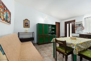 a living room with a table and a green cabinet at St. Bečić in Poreč +8 photos