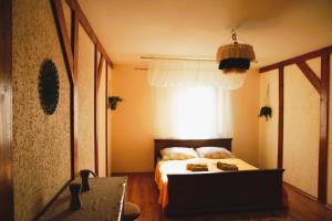 a bedroom with a bed and a window at Apartament ZAMURNA 4 in Golub-Dobrzyń