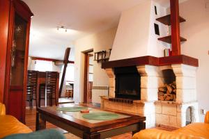 a living room with a fireplace and a table at Apartament ZAMURNA 4 in Golub-Dobrzyń