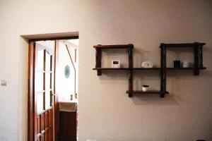 a room with two wooden shelves on the wall at Apartament ZAMURNA 4 in Golub-Dobrzyń