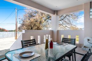 a dining room with a glass table and chairs at Villa Elida 