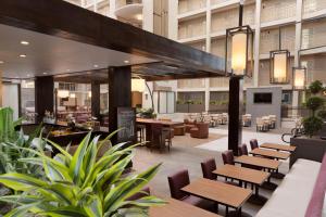 a restaurant with tables and chairs in a building at Embassy Suites by Hilton El Paso in El Paso